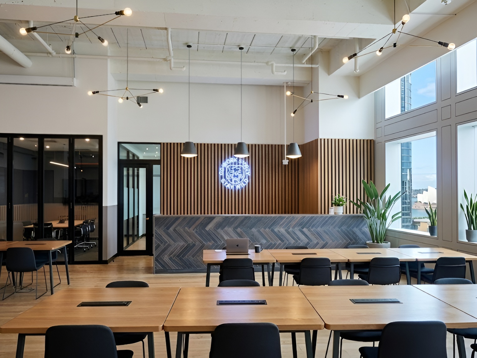 Coworking floor with herringbone-clad reception, custom millwork, and exposed services, representative project type